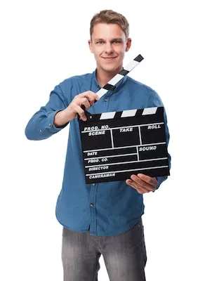 Man smiling with a clapperboard