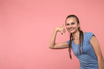 Front view of young girl smiling on pink