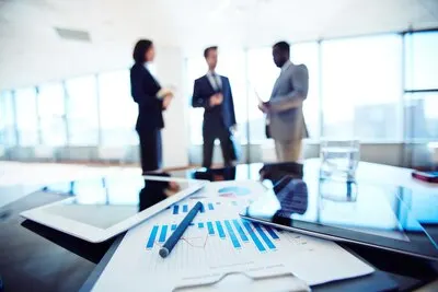 Close-up of clipboard with workers background