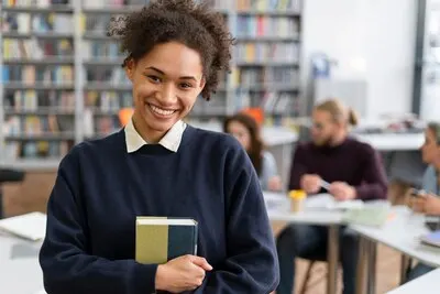 Medium shot smiley woman holding book