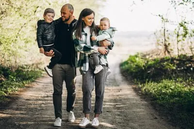 Young parents with their kids in the forest