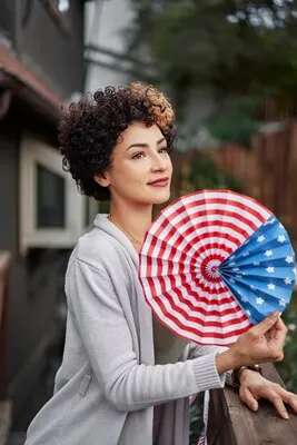 Medium shot smiley woman celebrating 4th of july