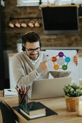 Happy entrepreneur analyzing business chart during web conference at home