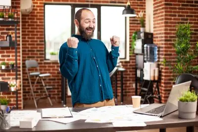 Businessman clenching fists in triumph