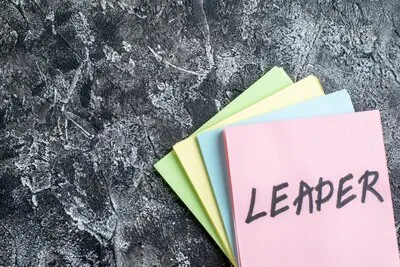 top view leader written note with stickers on gray background