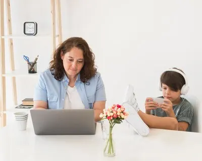 Mother with child working on laptop