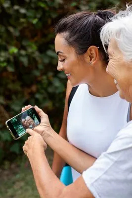 Portrait of two female friends with different ages outdoors