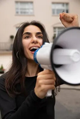 Woman shouting into a megaphone close up