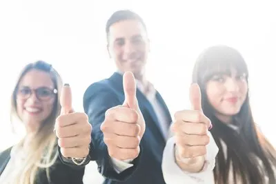 Group of business people showing thumb up sign