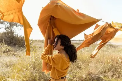Woman next to clothesline in fields