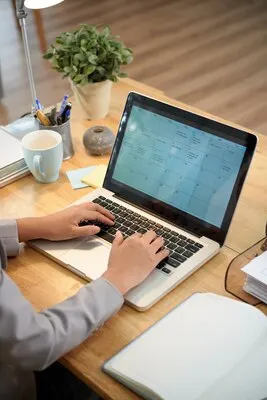 High angle view of cropped man filling online calendar