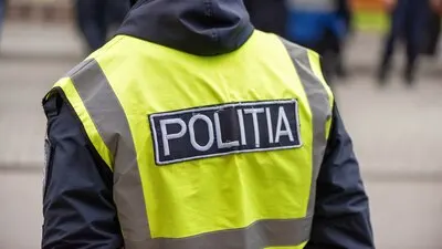 Policeman and people protesting for snap elections in front of constitutional court building