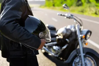 Side view man with a motorbike
