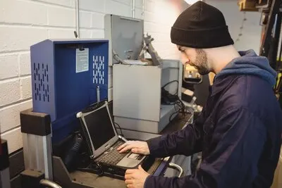 Mechanic using laptop