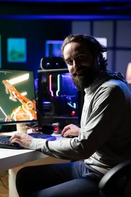 Close up of cheerful gamer streaming game in neon lit studio