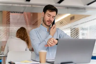 Young business man working at her desk with laptop