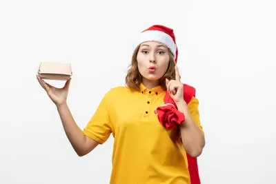 Close up on young pretty woman wearing Christmas hat isolated