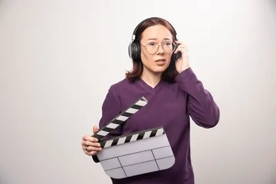 Young woman holding a cinema tape on a white . High quality photo