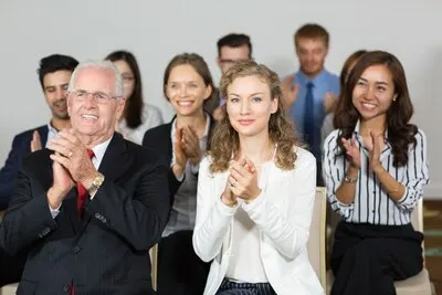 Group of business people clapping