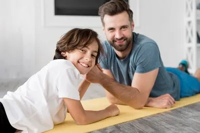 Kid and his father doing sport at home